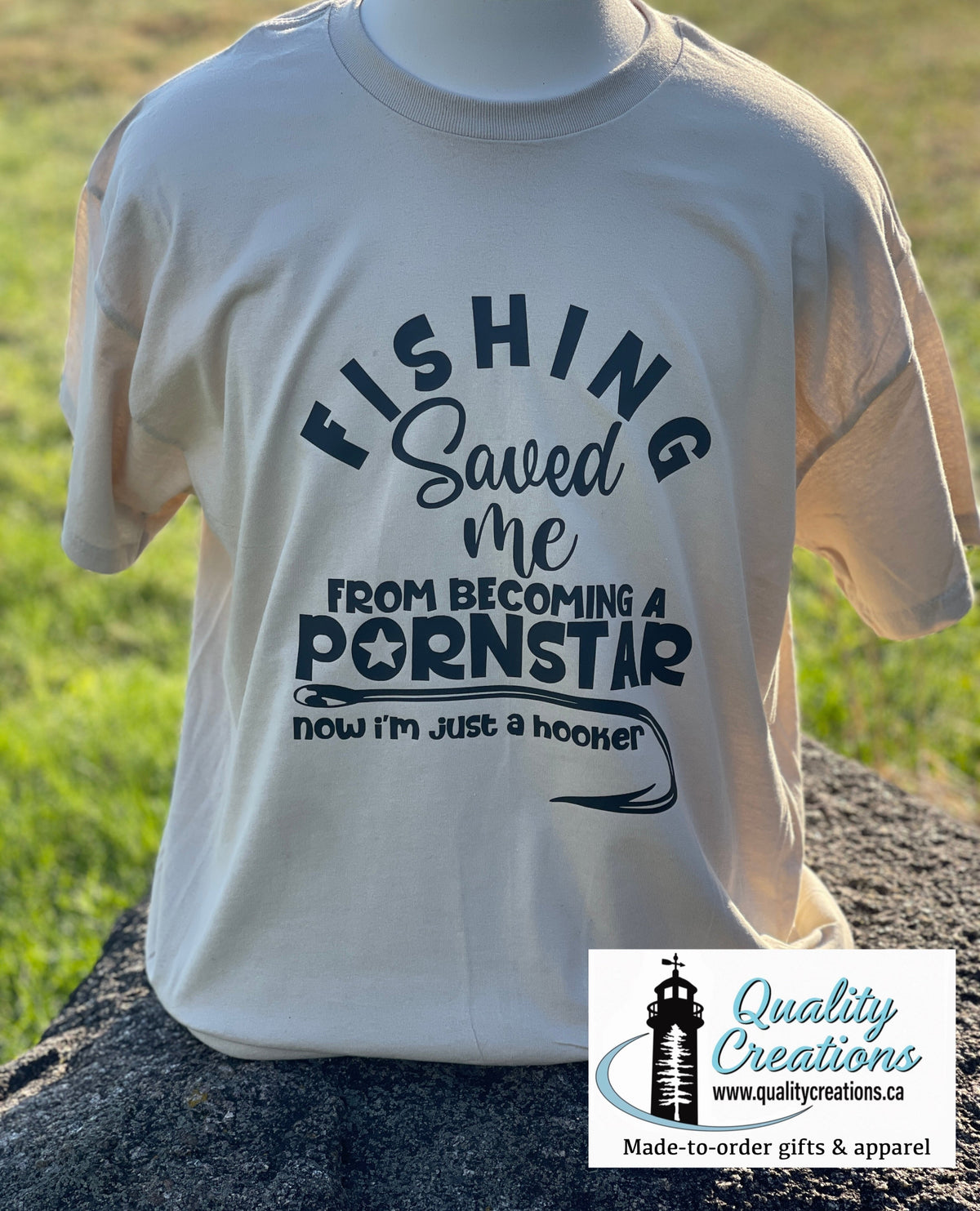Cream coloured fishing T-shirt with dark laddering and a funny fishing scene, made by Quality Creations in Salisbury, New Brunswick Canada