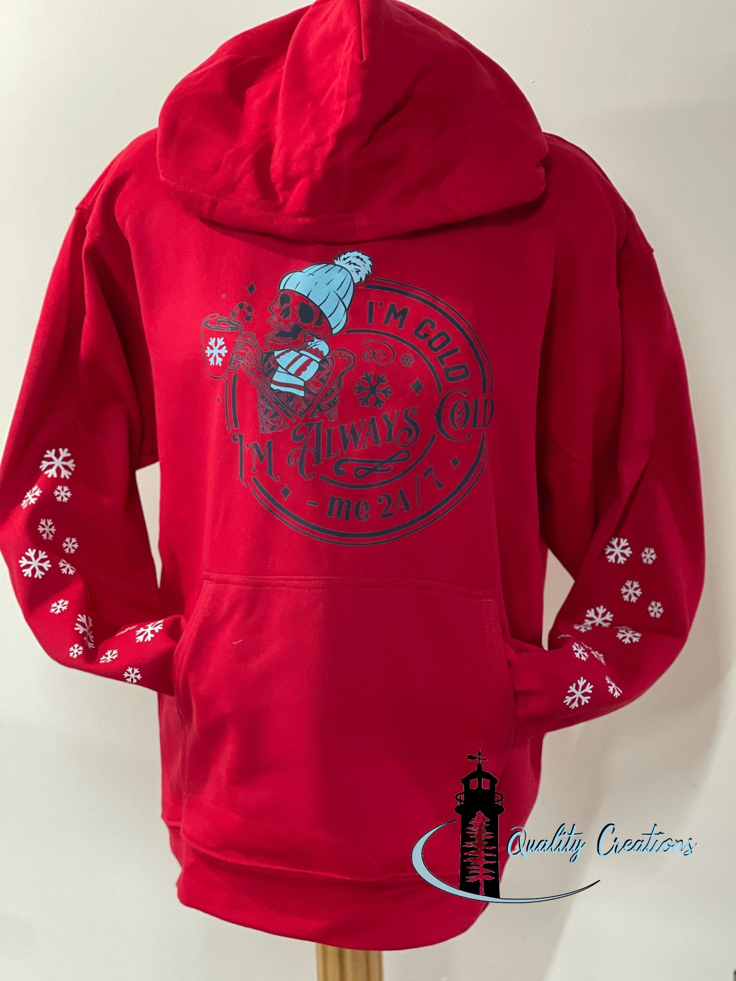 Custom red hoodie with “I’m Cold 24/7” design and snowflake prints on both sleeves by Quality Creations