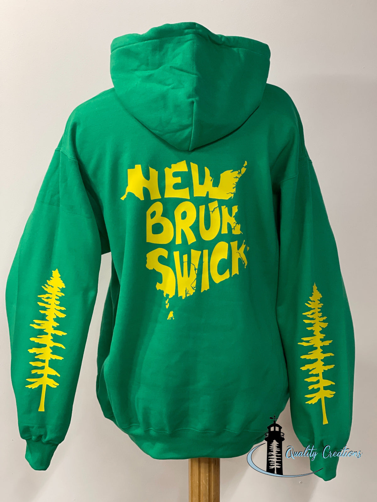 Kelly Green New Brunswick hoodie with yellow New Brunswick back graphic and pine tree sleeve designs, custom apparel made in Salisbury, New Brunswick, near Moncton and Fredericton, Canada.