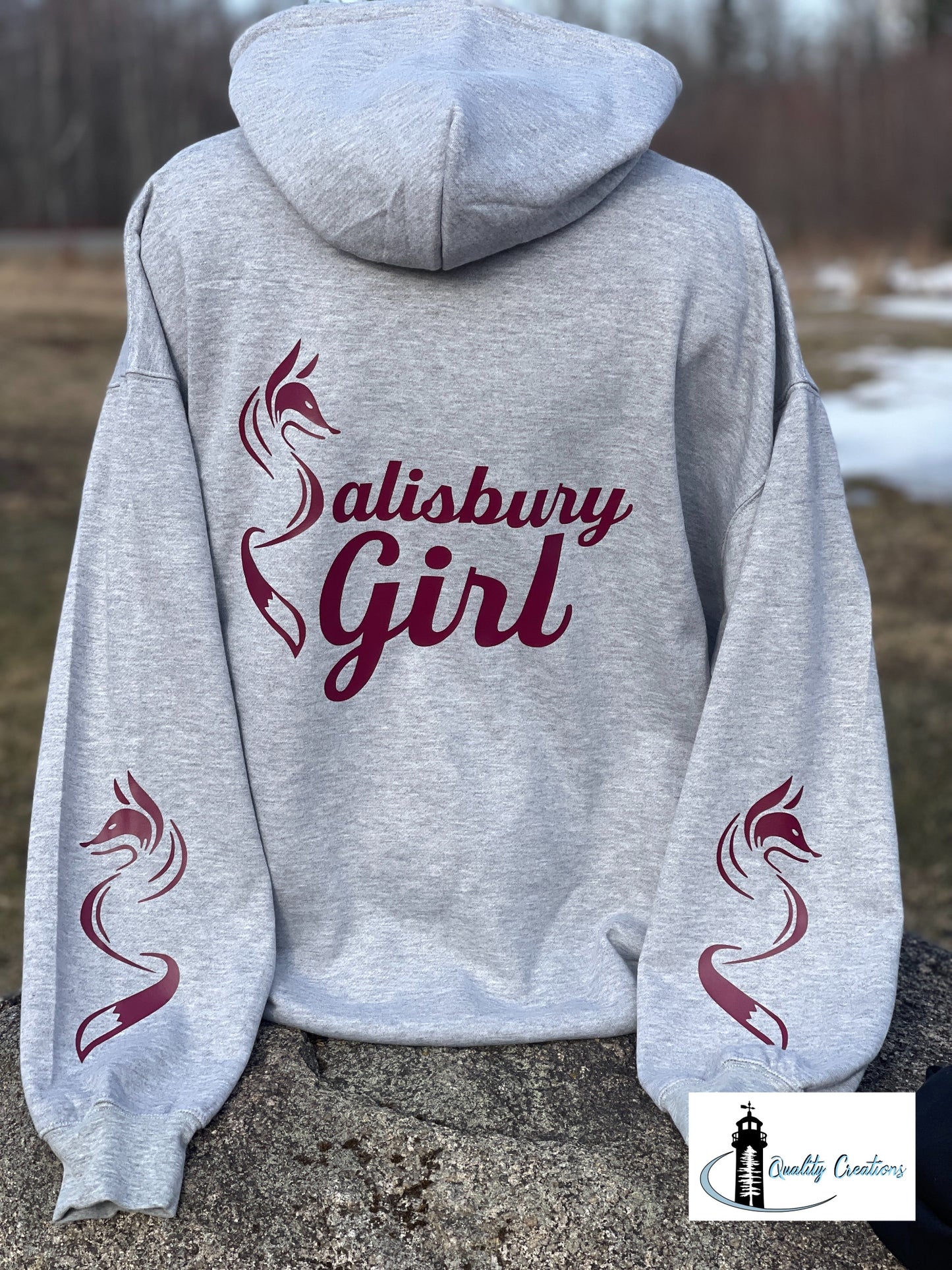 Heather grey Salisbury Girl pullover hoodie with burgundy text and fox sleeve graphics. A cozy and versatile style for locals from Salisbury, Moncton, Sussex, and Hampton, New Brunswick.