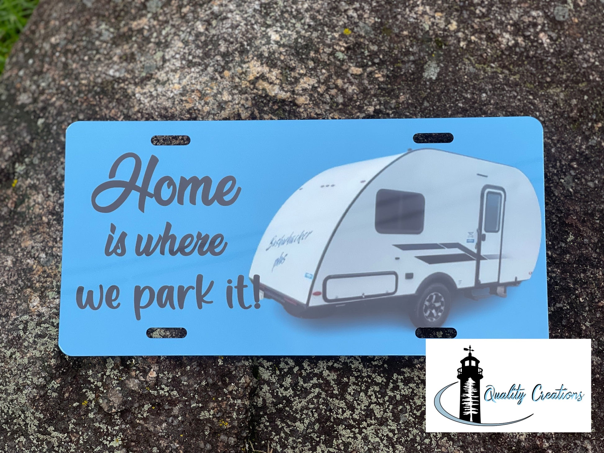 Home is where we park it decorative camper license plate featuring a travel trailer, a fun camping accessory by Quality Creations