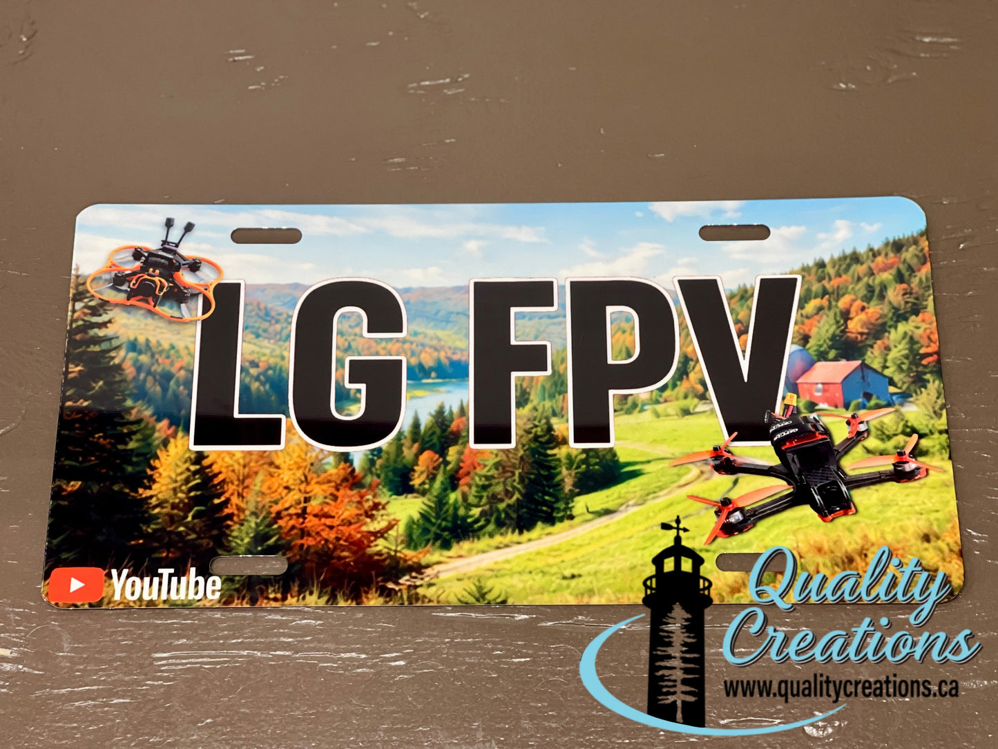 Custom LG FPV YouTube channel license plate featuring drone imagery and personalized creator branding by Quality Creations